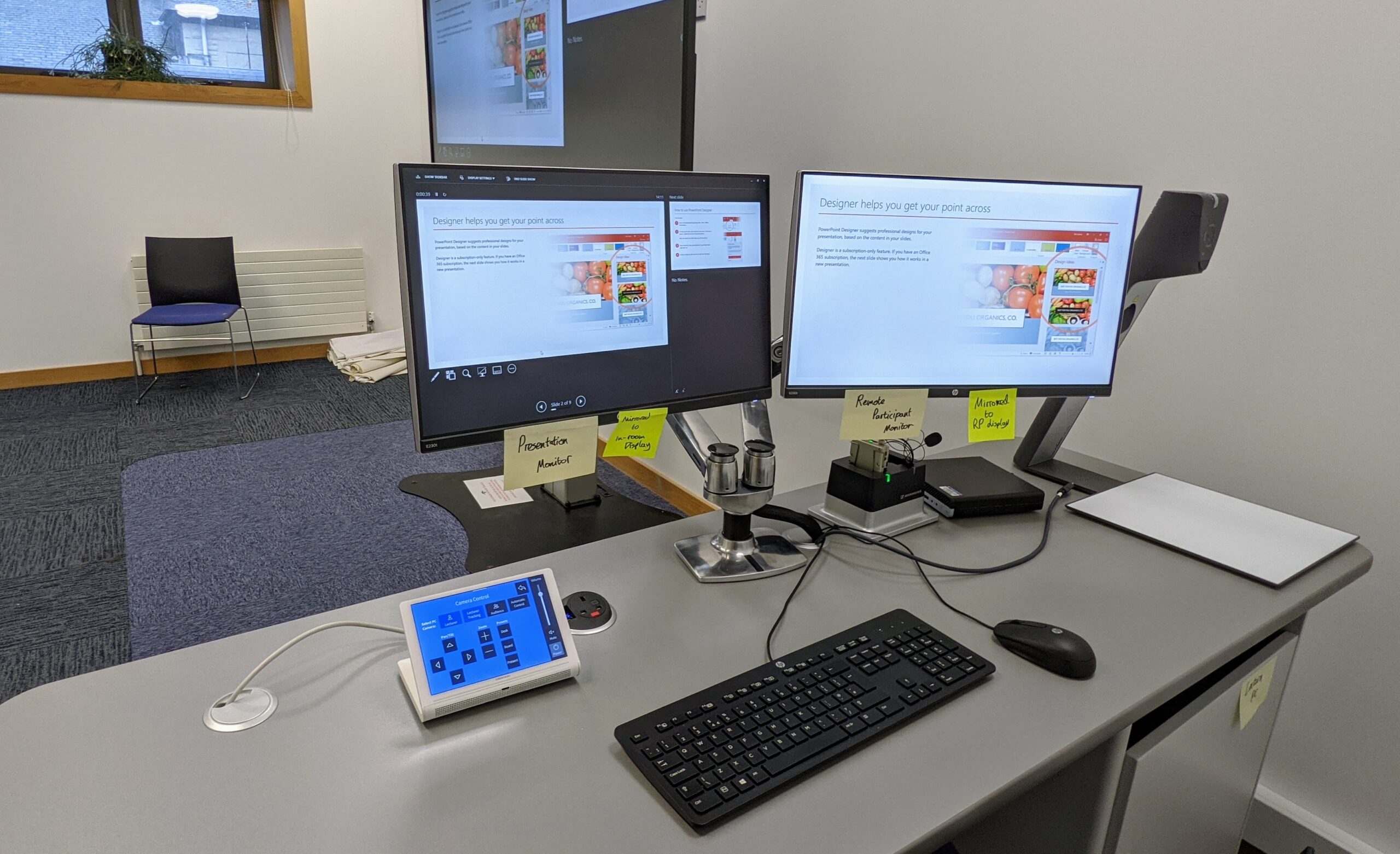 Image of Eduzone from the perspective of the lectern desk including twin monitors and large presentation screen 